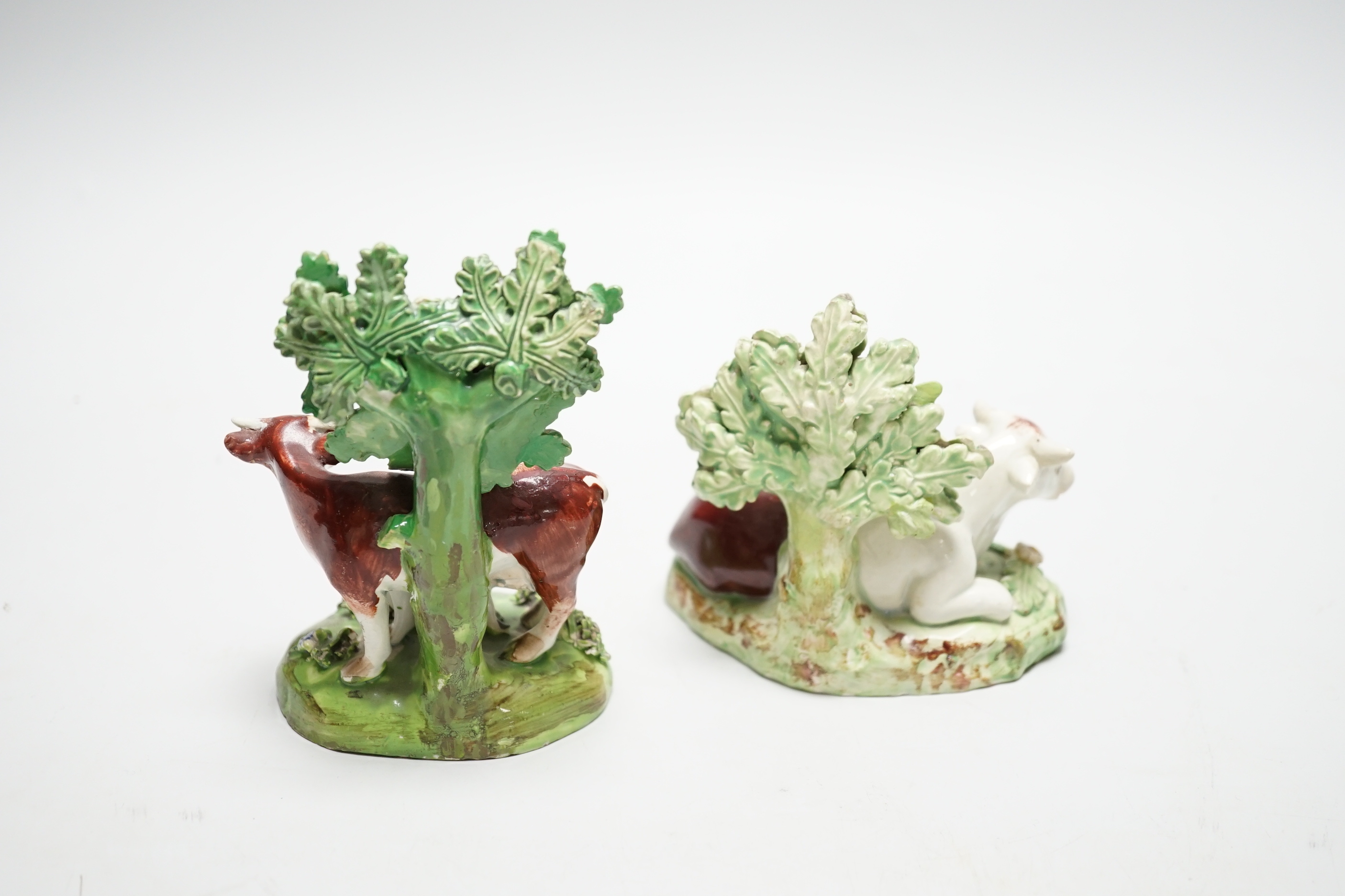 Two Staffordshire pearlware cow groups, c.1820-30, tallest 12cm